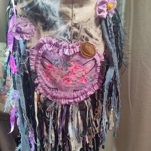 Handmade upcycled collage fringe purse with adjustable strap.